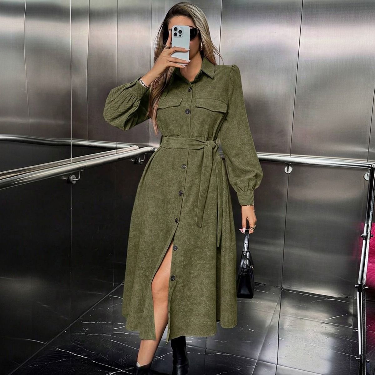 Mujer con vestido camisero midi verde oliva en cotele con cinturon anudado y mangas globo tomando selfie