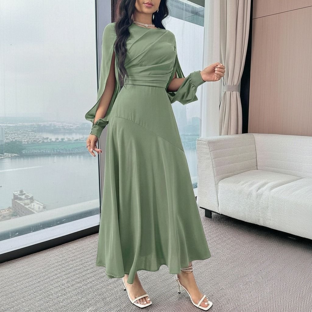 Vestido midi verde salvia con abertura en manga capa y puño globo visto en plano medio frontal